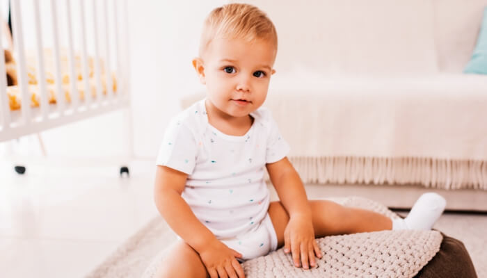 cute toddler on changing pad