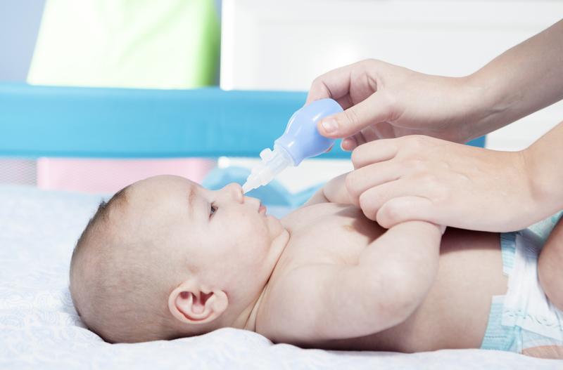 baby nose being cleaned with a nasal aspirator