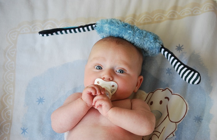 baby with a pacifier in its mouth