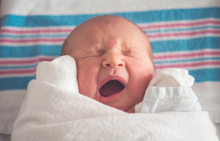 closeup on a newborn yawning 