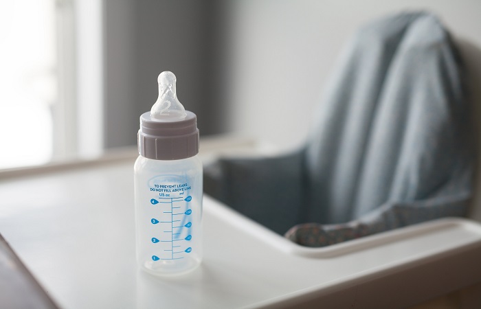 empty baby bottle on a feeding table 
