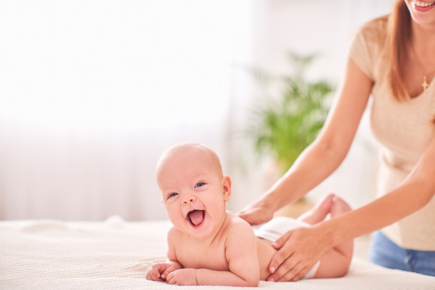 Happy baby receiving a massage